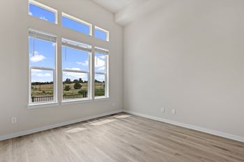 A room with a large window overlooking a landscape.